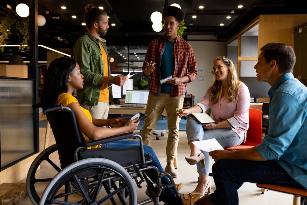 A diverse group of colleagues discuss a collaborative project